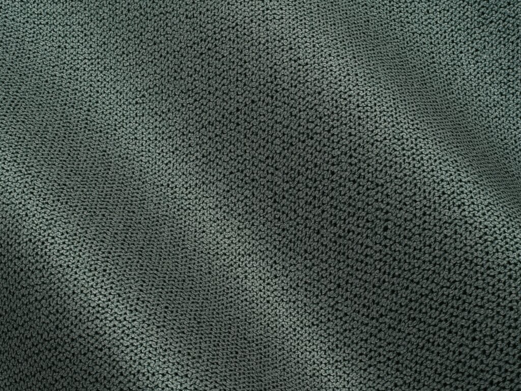 Detailed view of a textured fabric with subtle waves, showcasing a woven pattern.