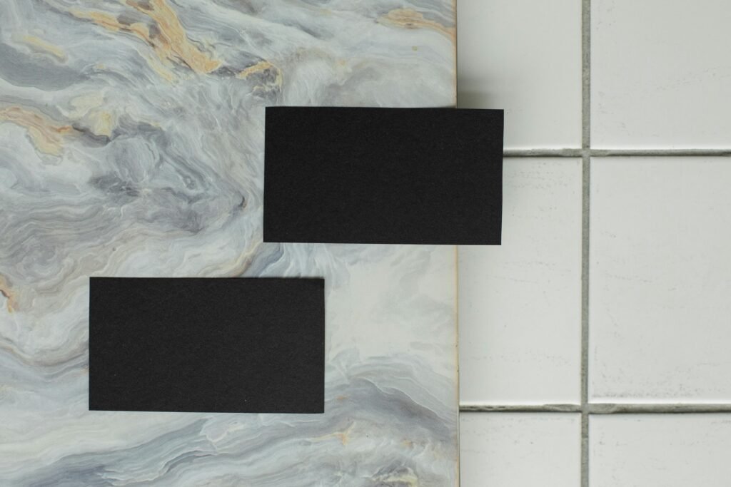 Privacy Policy Minimalist black business cards placed on elegant marble and tile surface with copyspace.